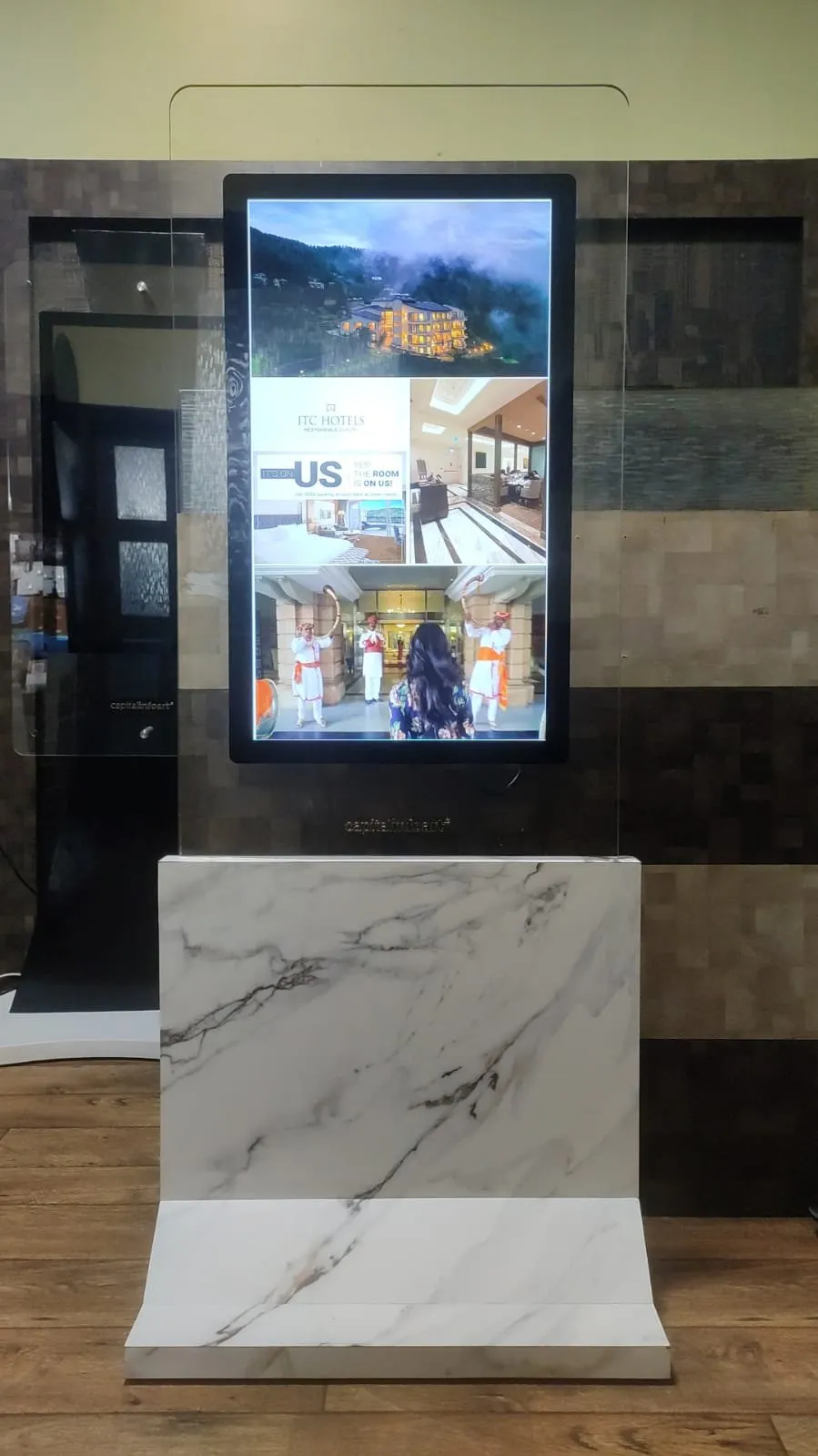 Premium glass kiosk on a marble-effect base in the Capital Infoart experience centre