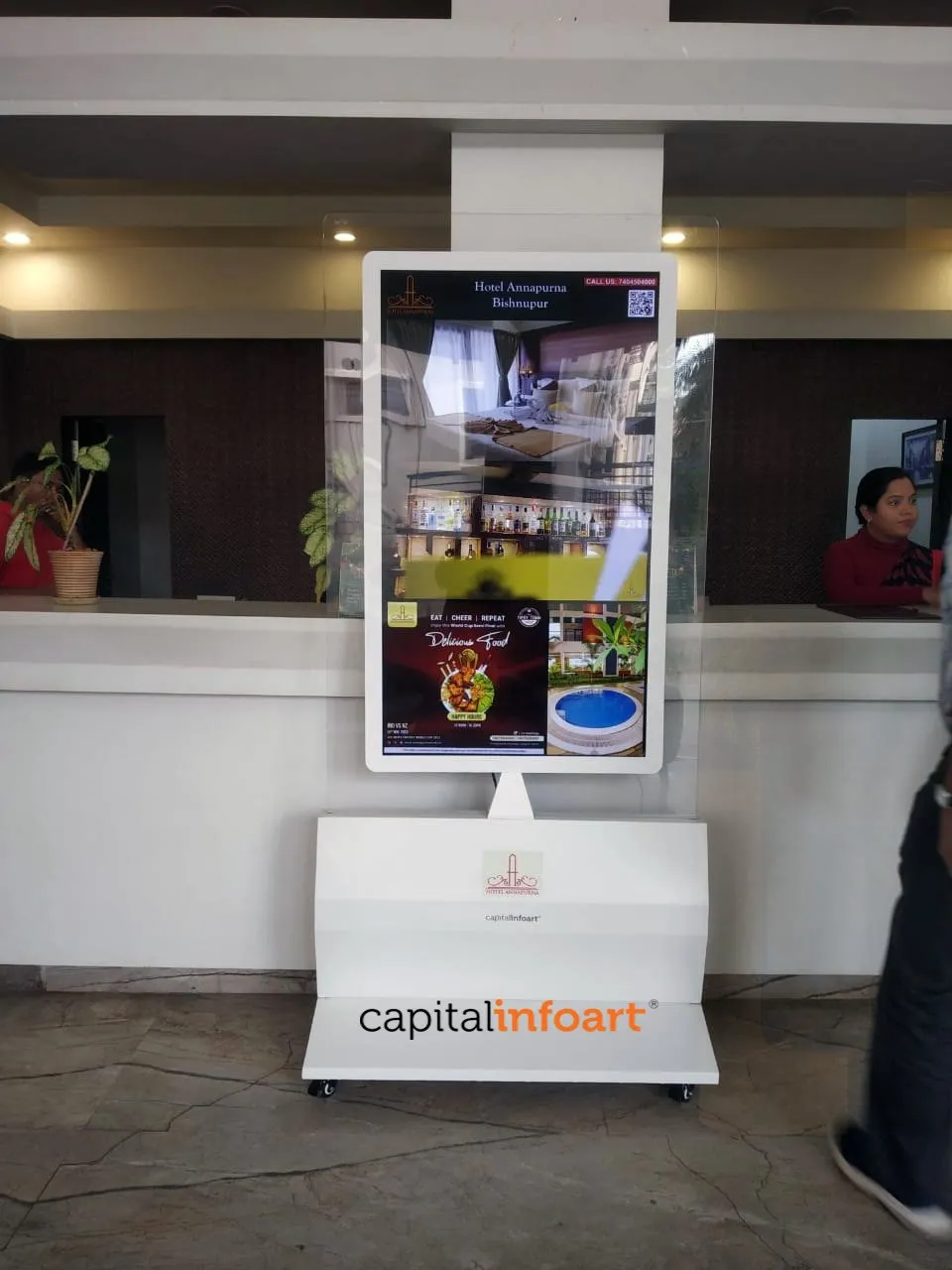 Premium glass kiosk installed beside a hotel reception counter