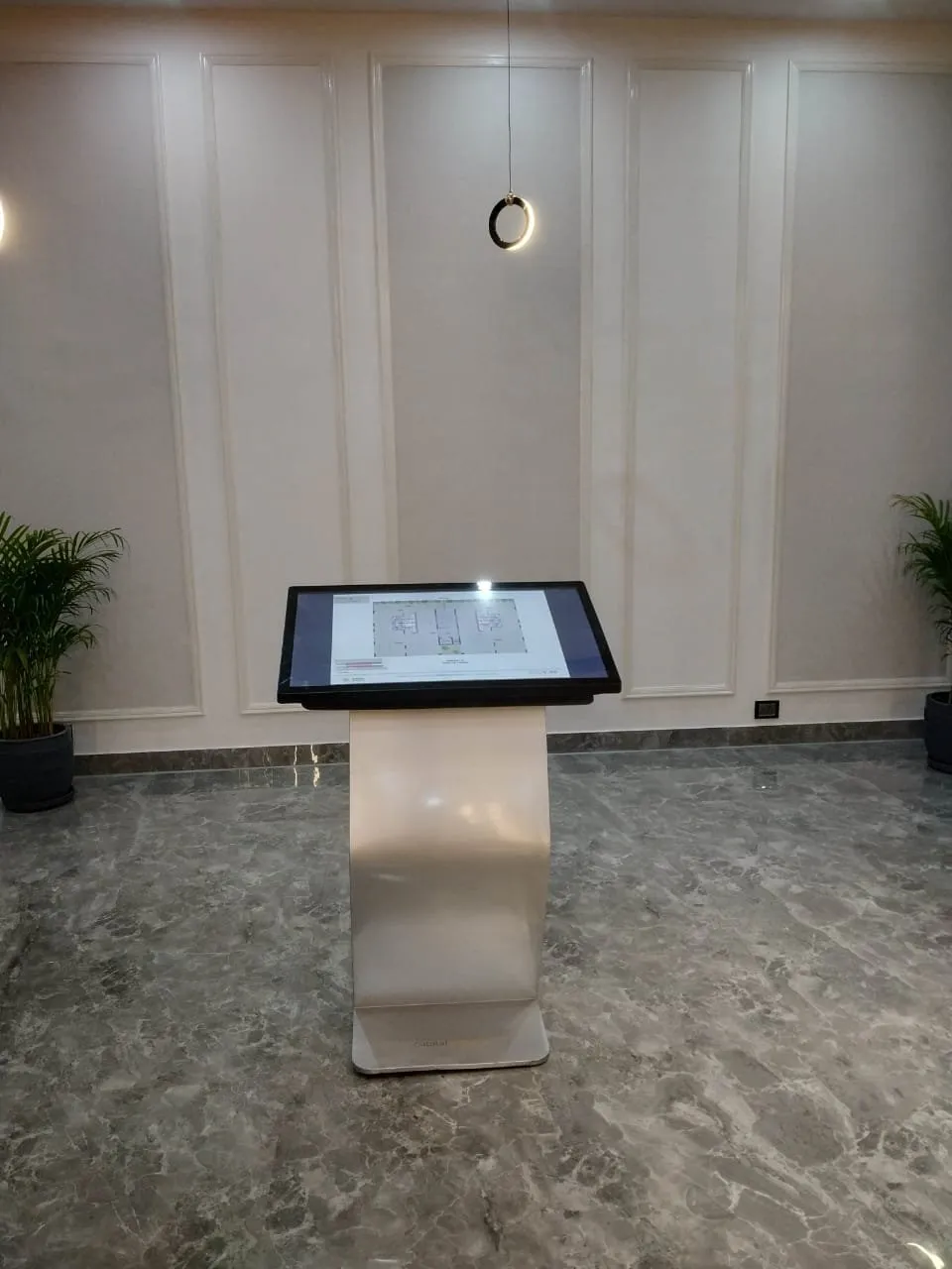 Interactive kiosk installed in a marble-floored lobby at Bengal Shristi