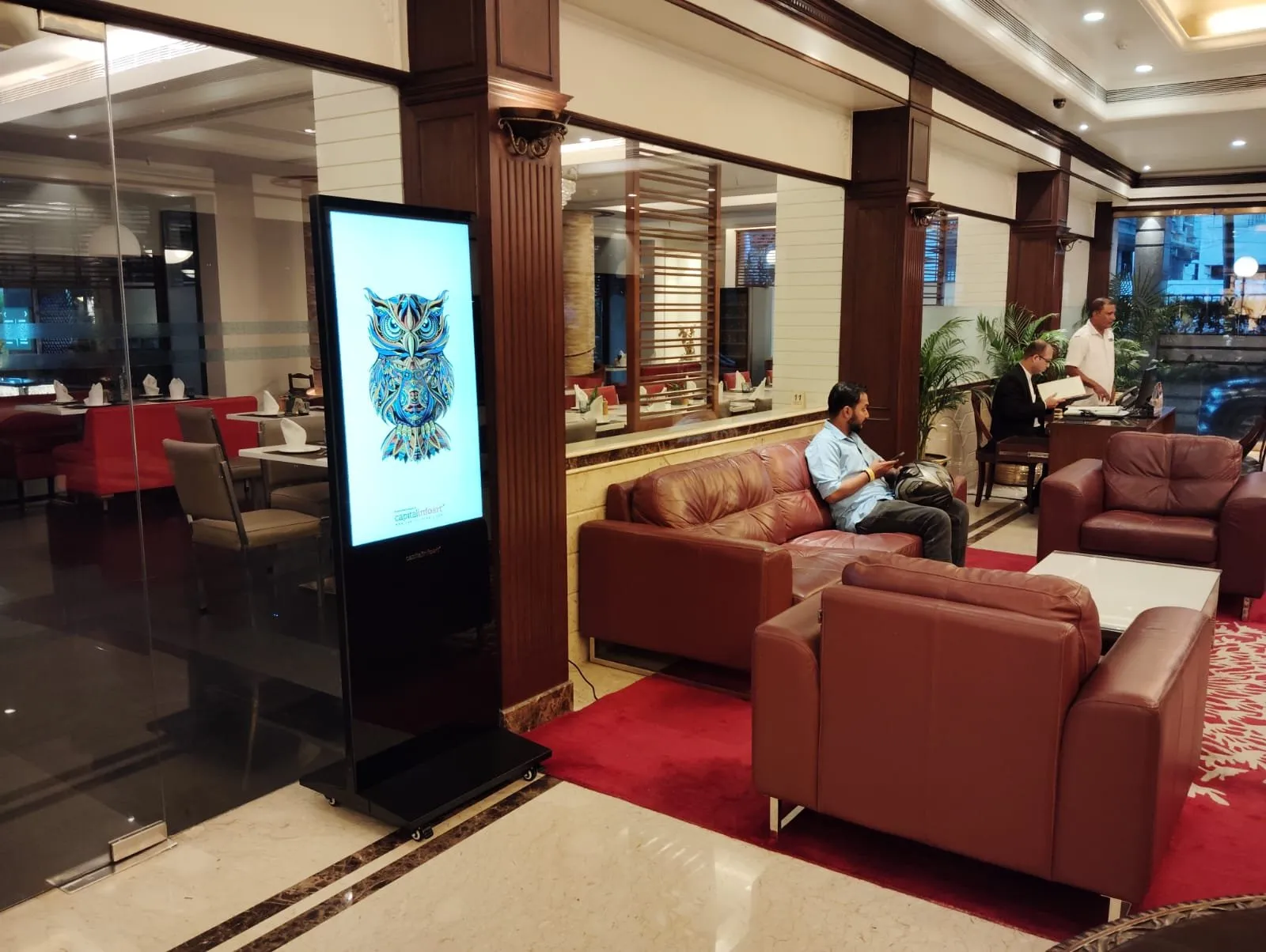 T-Type kiosk installed beside leather sofas in a hotel lounge